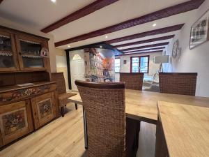 a dining room with a wooden table and chairs at B'm Yerri - Centre ville - vue Cathédrale in Colmar