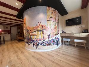 a large painting on the wall in a room at B'm Yerri - Centre ville - vue Cathédrale in Colmar