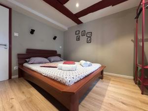 a bedroom with a bed with two towels on it at B'm Yerri - Centre ville - vue Cathédrale in Colmar