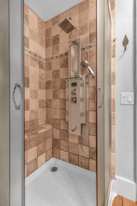 a shower with a glass door in a bathroom at 4 bedroom house with hot tub Near Ellicottville in West Valley