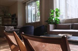 a living room with a couch and a table and chairs at c-hotels Atlantic in Milan