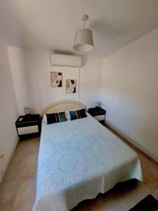 a bedroom with a bed and two night stands at ANDRIA in Peristerona