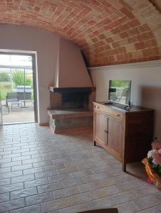 a living room with a table and a piano at Country House L'Oliveto in Marta