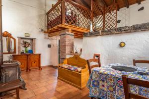 a room with a bed and a table in it at Etnalandhauser in Piedimonte Etneo