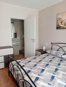 a bedroom with a large bed and a bathroom at Country House L'Oliveto in Marta