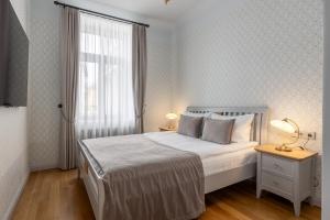 Postel nebo postele na pokoji v ubytování Roze Kūrmājas Residence