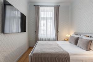 Postel nebo postele na pokoji v ubytování Roze Kūrmājas Residence