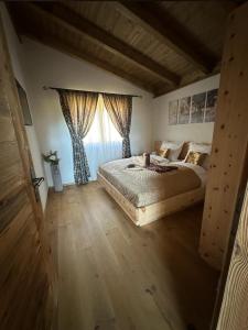 a bedroom with a large bed and a window at Alpenchalet Waldruhe in Scheffach