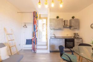 a kitchen with a table and a dining room at Wendy House in Stintino +28 photos