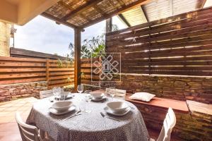 a table and chairs sitting on a patio at Wendy House in Stintino