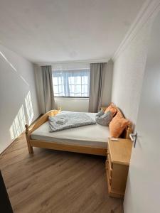 a bedroom with a large bed with a window at In & Out Boardinghaus in Stolberg