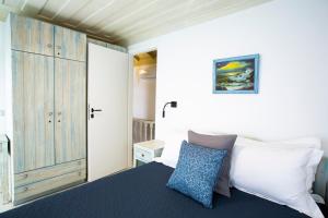 a bedroom with a large bed and a closet at Villa Annouska in Halki