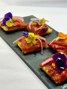 einen Teller Essen mit Blumen drauf in der Unterkunft Glen Dessary Estate - Fully Catered Bespoke Highland Lodge in Spean Bridge