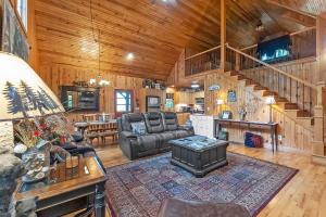 a living room with a couch and a table at Mountain Getaway with Hot Tub & Game Room cabin in Cleveland