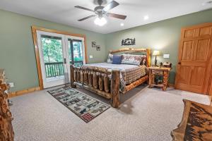 a bedroom with a bed and a ceiling fan at Mountain Getaway with Hot Tub & Game Room cabin in Cleveland