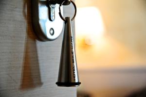 a metal keychain hanging on a wall at Sole Mare in Ventimiglia
