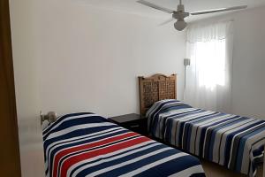 two beds sitting next to each other in a room at Cómodo departamento en el corazón de Cancún in Cancún