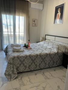 a bedroom with a bed with a table on it at Teo Apartment in Iraklitsa