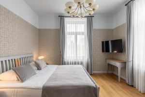 Postel nebo postele na pokoji v ubytování Roze Kūrmājas Residence