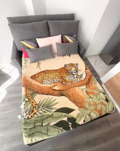 a bed with a leopard laying on a tree at 24 7 Open Apartment Parking 15'Paris 5'Athletica bis in Saint-Gratien +11 photos