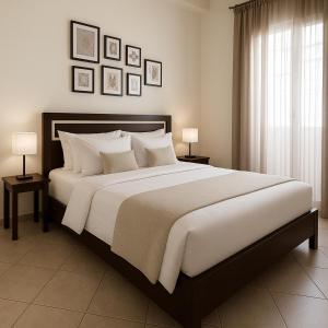 a bedroom with a large bed with two tables and two lamps at Gony's Apartment in Orfánion