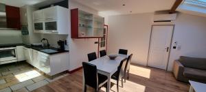 a kitchen and dining room with a table and chairs at Duplex climatise de 80m2 en plein coeur de la vieille ville in Toulon