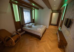 a bedroom with a bed and a television in it at Casa Danciu in Fînaţe