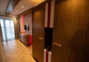 a room with a wooden closet with a television in it at Casa Danciu in Fînaţe
