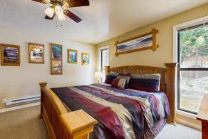 a bedroom with a bed and a ceiling fan at Aspen Village Golf Course Condo - Snowshoes in McCall +23 photos