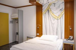Postelja oz. postelje v sobi nastanitve Albergo Carcani by Ketty & Tommy