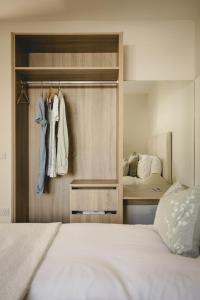 a bedroom with a bed and a closet at The Old Schoolhouse - Teacher's Quarters in Donegal