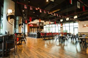 a restaurant with wooden floors and tables and chairs at Holiday Inn Abu Dhabi by IHG in Abu Dhabi