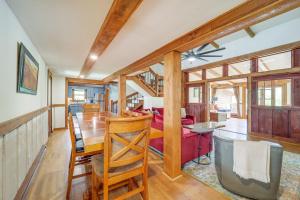 a dining room and living room with wood beams at 2 Mi to Appalachian State Cabin with Outdoor Spaces in Boone