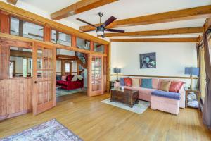 a living room with a couch and a ceiling fan at 2 Mi to Appalachian State Cabin with Outdoor Spaces in Boone