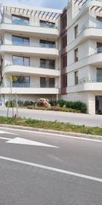 an empty street in front of a building at ATEA PERLA apartments in Kavarna