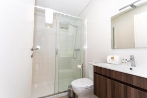 a bathroom with a shower and a toilet and a sink at GuestReady - Passal Guesthouse in Ponta Delgada