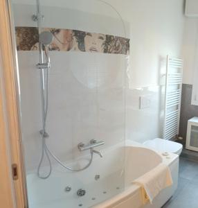 a bathroom with a shower and a bath tub at Armonia Affittacamere in San Vicenzo di Galliera +36 photos
