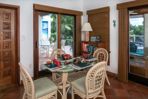 a dining room with a glass table and chairs at Cielo Vista Villa 3 BDRM Sleeps 6 Heavenly View in Cruz Bay