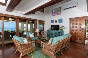 a living room with wicker chairs and a table at Cielo Vista Villa 3 BDRM Sleeps 6 Heavenly View in Cruz Bay