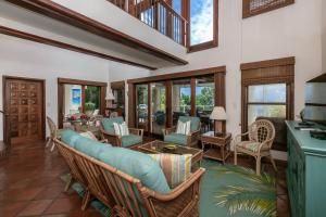 a living room with chairs and tables and windows at Cielo Vista Villa 3 BDRM Sleeps 6 Heavenly View in Cruz Bay