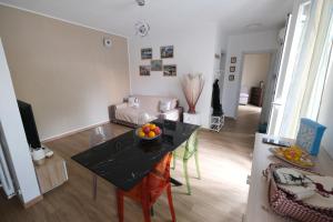 a living room with a table with a bowl of fruit on it at Casa Diana by PortofinoVacanze in Rapallo