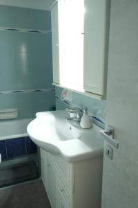 a bathroom with a white sink and a mirror at Casa Diana by PortofinoVacanze in Rapallo +28 photos