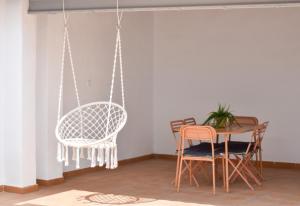 a dining room with two chairs and a table at Global Properties, Les Villetes - Magdalena in Moncófar