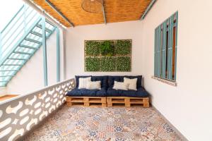 a room with a blue couch on a balcony at Global Properties, Les Villetes - Magdalena in Moncófar