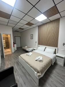a bedroom with a large bed with towels on it at Loft Office in Castel Maggiore