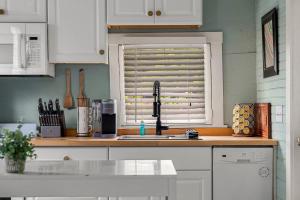 a kitchen counter with a sink and a window at Hot Tubs - DT Duplex - Two Blocks off Forsyth Park in Savannah