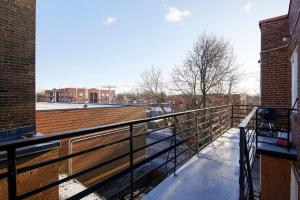 a balcony with a wooden railing on a building at Beautiful 2BR on Walkley in Montréal