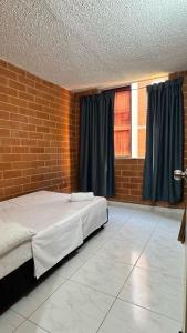 Ένα ή περισσότερα κρεβάτια σε δωμάτιο στο Habitacion Brisas Ricaurte