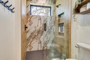 a bathroom with a shower with a glass door at Fireplace and EV Charger! Home in Torreon Community in Show Low +28 photos