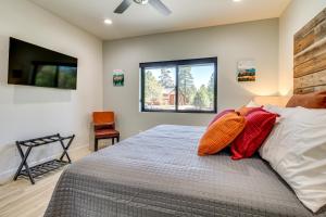 a bedroom with a bed with red pillows on it at Fireplace and EV Charger! Home in Torreon Community in Show Low